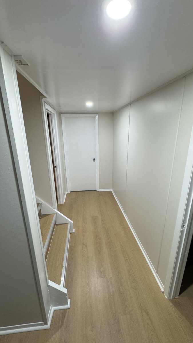 Hallway after laminate flooring and new baseboard, Saskatoon